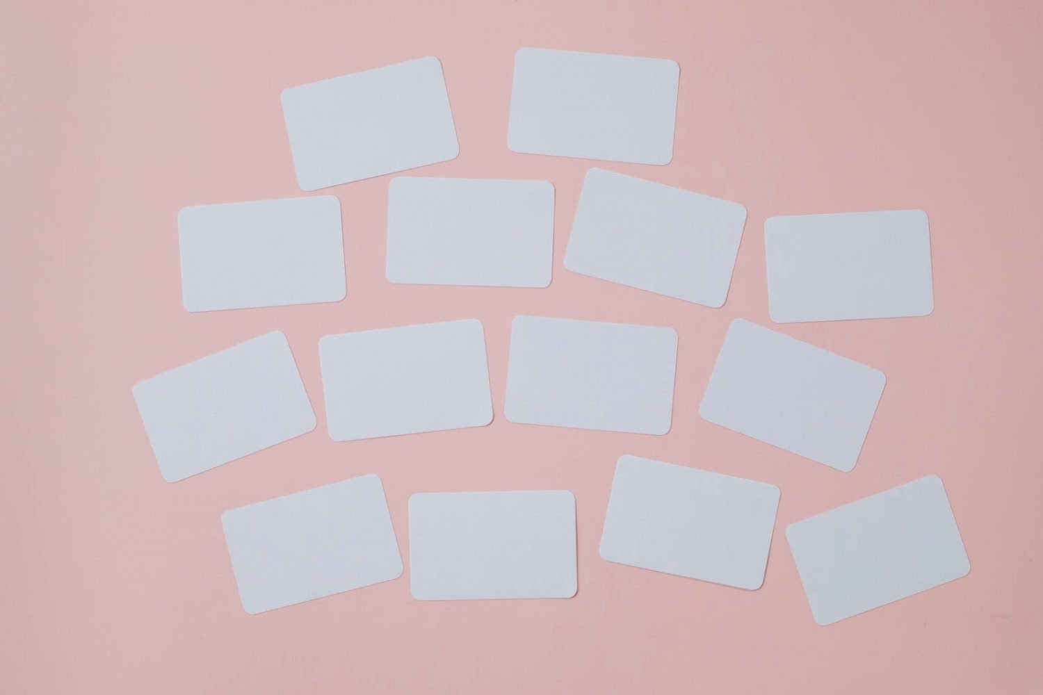 Set of empty white papers attached on pink wall